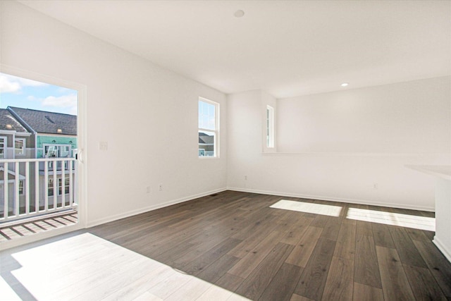unfurnished room featuring wood finished floors and baseboards