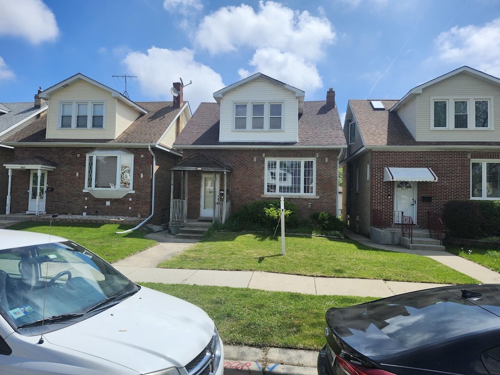 3631 N Oriole Ave, Chicago, IL 60634 - view of front of property featuring brick siding and a front yard