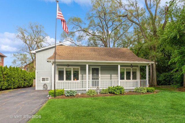 6N715 Gates Ave, Itasca, IL 60143 - view of front of home with covered porch, a front lawn, driveway, and roof with shingles