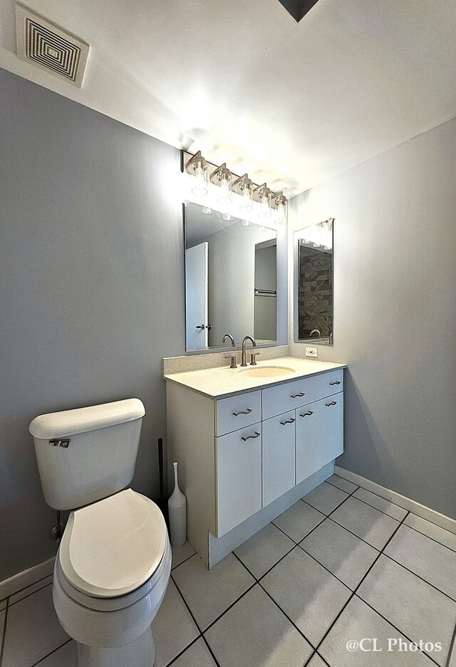 1580 Sherman Ave Unit 1005, Evanston, IL 60201 - bathroom with tile patterned flooring, toilet, vanity, and baseboards