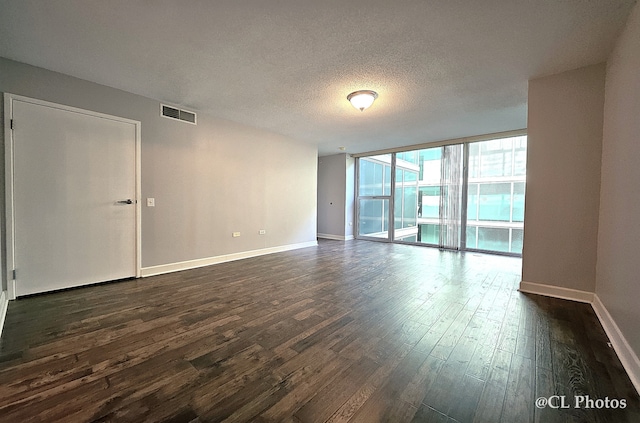 1580 Sherman Ave Unit 1005, Evanston, IL 60201 - unfurnished room with dark wood-type flooring, baseboards, a textured ceiling, and a wall of windows