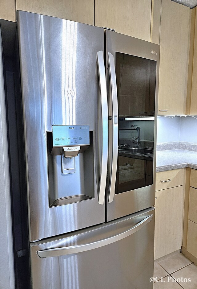 1580 Sherman Ave Unit 1005, Evanston, IL 60201 - kitchen featuring stainless steel fridge, light countertops, and light tile patterned floors