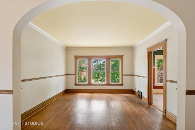 7223 Jackson Blvd, Forest Park, IL 60130 - empty room with crown molding, wood finished floors, baseboards, and arched walkways
