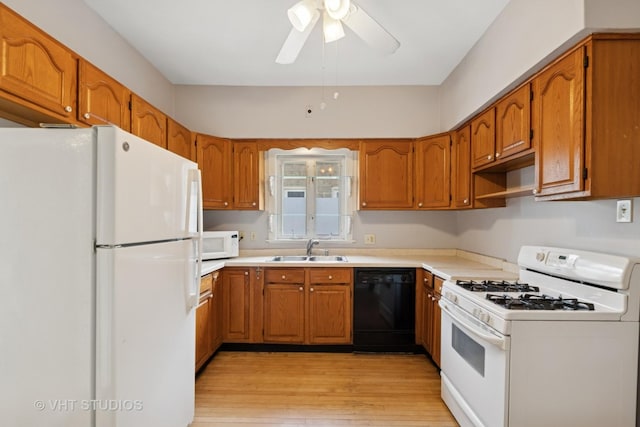 7223 Jackson Blvd, Forest Park, IL 60130 - kitchen featuring white appliances, a sink, brown cabinetry, light wood-style floors, and ceiling fan