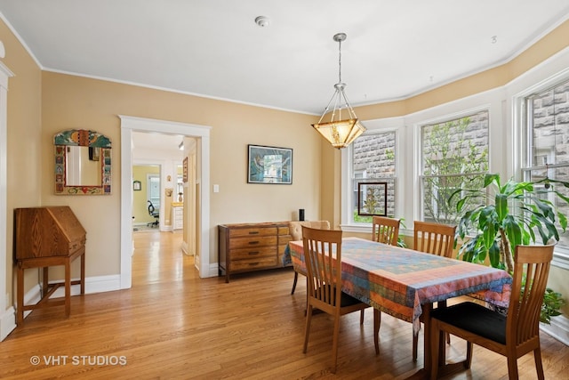 7223 Jackson Blvd, Forest Park, IL 60130 - dining room with plenty of natural light, light wood-style flooring, crown molding, and baseboards