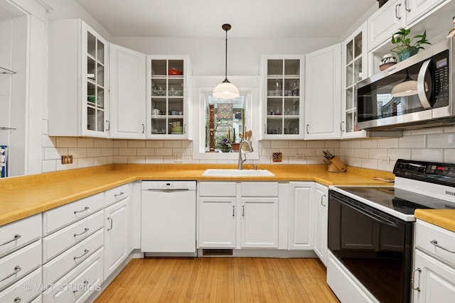 7223 Jackson Blvd, Forest Park, IL 60130 - kitchen with electric range, white dishwasher, stainless steel microwave, a sink, and white cabinets