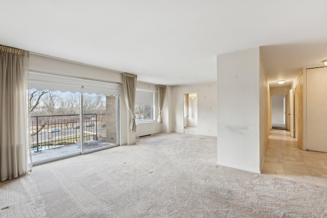 unfurnished living room featuring carpet floors