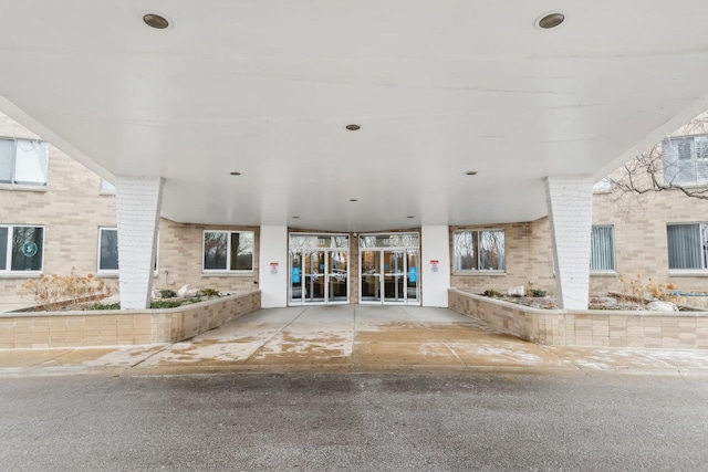 entrance to property featuring brick siding