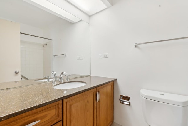 full bath featuring toilet, vanity, and a shower