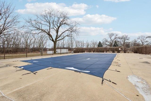 view of swimming pool featuring fence and a patio area