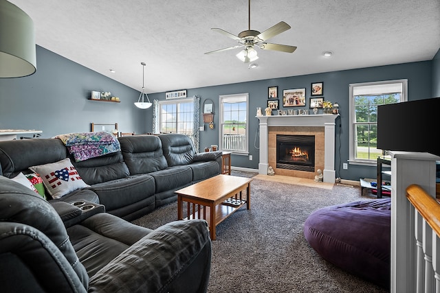 421 Sunset Dr, Colfax, IL 61728 - living room featuring a ceiling fan, baseboards, healthy amount of natural light, a textured ceiling, and a tiled fireplace