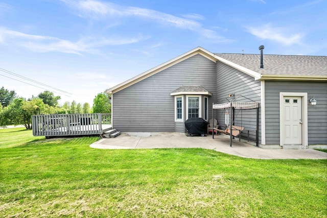 421 Sunset Dr, Colfax, IL 61728 - back of property with a patio, a wooden deck, a lawn, and a shingled roof