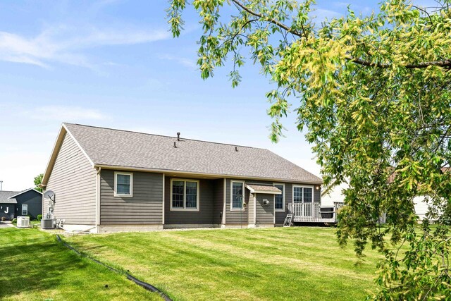 421 Sunset Dr, Colfax, IL 61728 - back of property featuring a lawn, a wooden deck, roof with shingles, and central air condition unit
