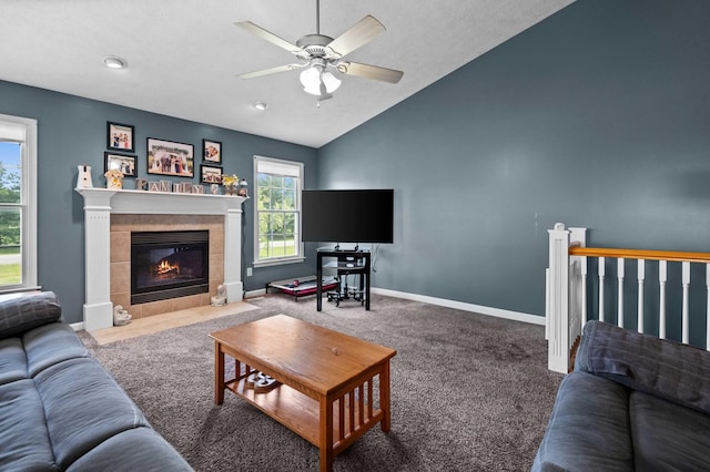 421 Sunset Dr, Colfax, IL 61728 - carpeted living room with lofted ceiling, a tiled fireplace, a ceiling fan, and baseboards