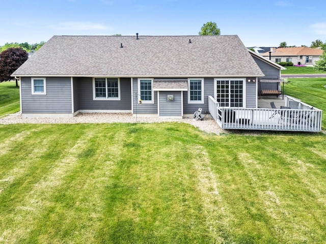 421 Sunset Dr, Colfax, IL 61728 - rear view of house with a shingled roof, a wooden deck, and a lawn