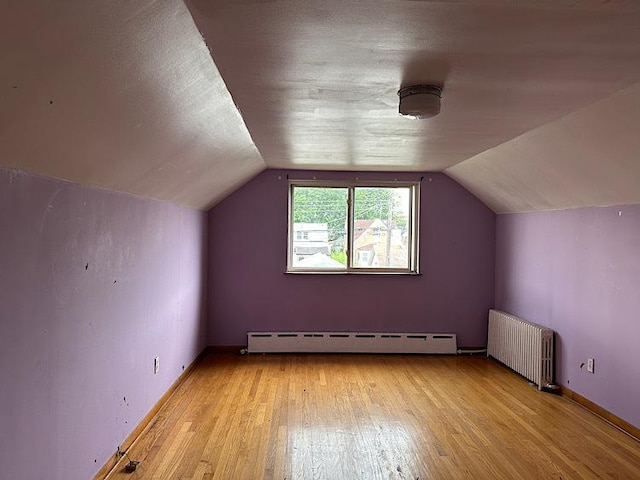 3010 N Nottingham Ave, Chicago, IL 60634 - bonus room featuring radiator, a baseboard heating unit, light wood-type flooring, and vaulted ceiling