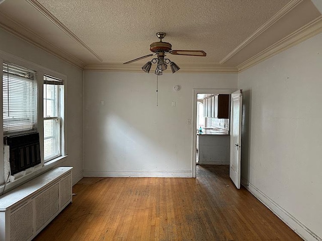 3010 N Nottingham Ave, Chicago, IL 60634 - spare room with radiator heating unit, a ceiling fan, wood finished floors, crown molding, and a textured ceiling