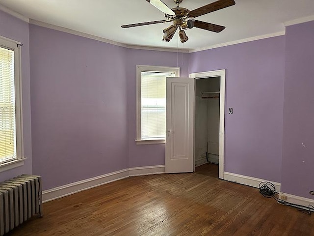 3010 N Nottingham Ave, Chicago, IL 60634 - unfurnished bedroom with radiator heating unit, wood finished floors, ornamental molding, and ceiling fan