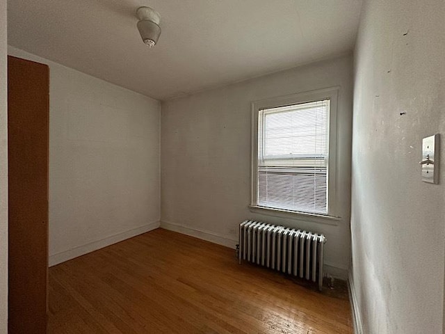 3010 N Nottingham Ave, Chicago, IL 60634 - spare room featuring radiator heating unit and wood finished floors