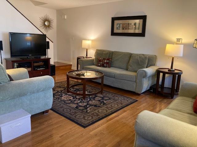 living room featuring wood finished floors and baseboards