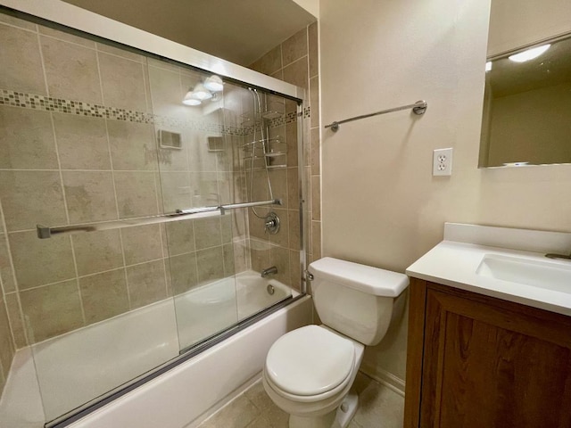 bathroom with toilet, vanity, and shower / bath combination with glass door