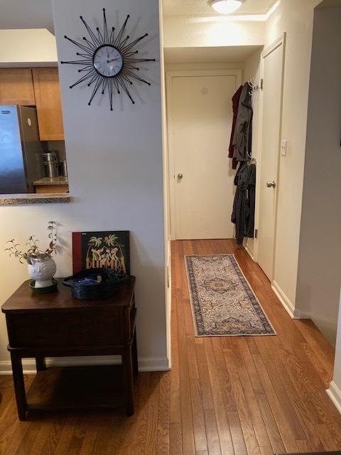 entryway featuring wood finished floors and baseboards