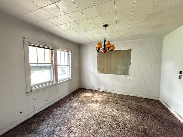 2843 N New England Ave, Chicago, IL 60634 - unfurnished dining area with a chandelier and carpet floors