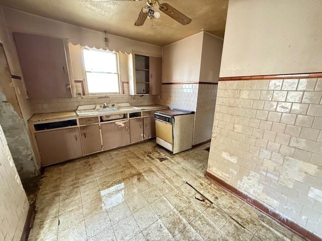 2843 N New England Ave, Chicago, IL 60634 - kitchen with a ceiling fan, light countertops, dishwasher, wainscoting, and light floors