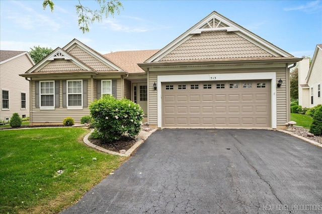 513 Coventry Ct, Oswego, IL 60543 - view of front of house featuring asphalt driveway, a front yard, and a garage