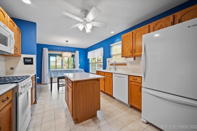 513 Coventry Ct, Oswego, IL 60543 - kitchen featuring white appliances, a center island, backsplash, light countertops, and recessed lighting