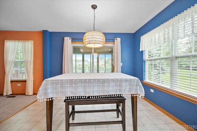 513 Coventry Ct, Oswego, IL 60543 - tiled dining space featuring plenty of natural light and baseboards