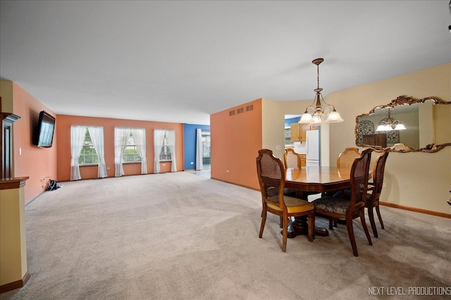 513 Coventry Ct, Oswego, IL 60543 - dining room with carpet floors, a chandelier, and baseboards