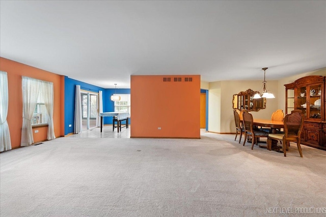 513 Coventry Ct, Oswego, IL 60543 - dining area with a chandelier, carpet flooring, and baseboards