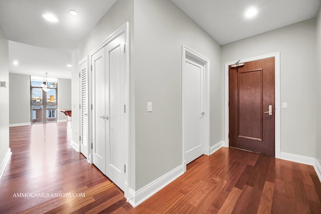 520 S Washington St Unit 201, Naperville, IL 60540 - hall featuring a chandelier, dark wood finished floors, baseboards, and recessed lighting