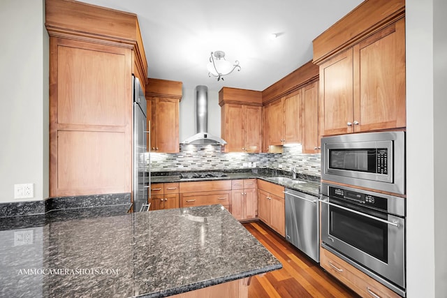 520 S Washington St Unit 201, Naperville, IL 60540 - kitchen with wall chimney range hood, stainless steel appliances, a sink, tasteful backsplash, and wood finished floors