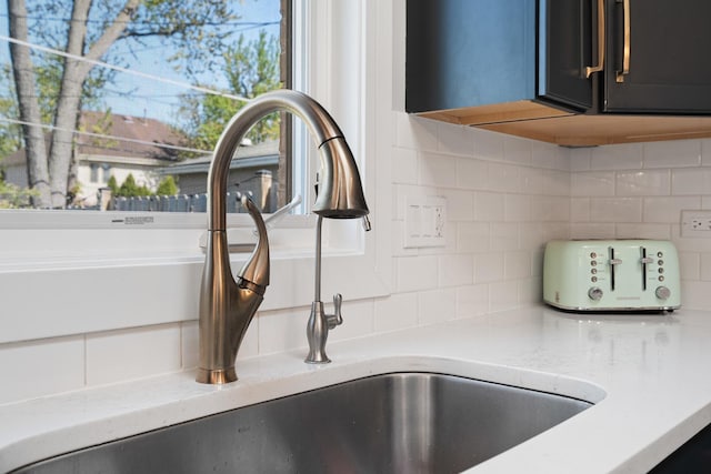 7929 N Octavia Ave, Niles, IL 60714 - kitchen view of tasteful backsplash, a sink, and light stone countertops