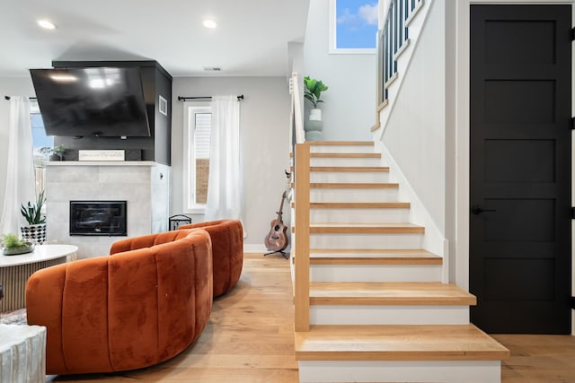7929 N Octavia Ave, Niles, IL 60714 - stairway with wood finished floors, a tiled fireplace, recessed lighting, and baseboards
