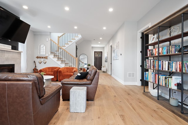 7929 N Octavia Ave, Niles, IL 60714 - living area with a tile fireplace, light wood-style flooring, stairway, recessed lighting, and baseboards