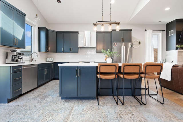 7929 N Octavia Ave, Niles, IL 60714 - kitchen featuring appliances with stainless steel finishes, wall chimney range hood, light countertops, a breakfast bar area, and vaulted ceiling