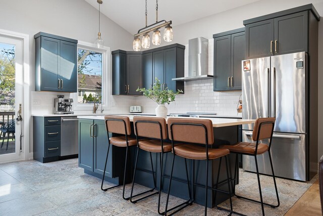 7929 N Octavia Ave, Niles, IL 60714 - kitchen featuring stainless steel appliances, wall chimney exhaust hood, lofted ceiling, light countertops, and a kitchen island