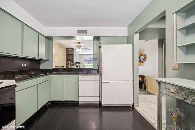 kitchen featuring white appliances, a sink, green cabinetry, and open shelves