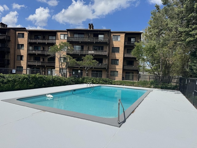 community pool featuring fence