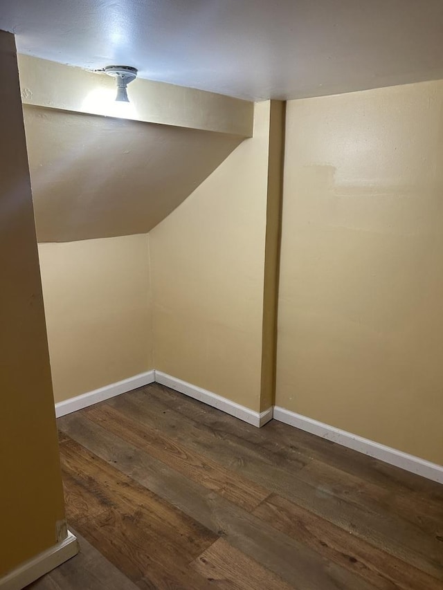bonus room with wood finished floors, lofted ceiling, and baseboards