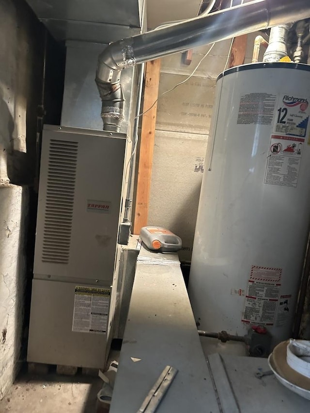 utility room featuring gas water heater and heating unit