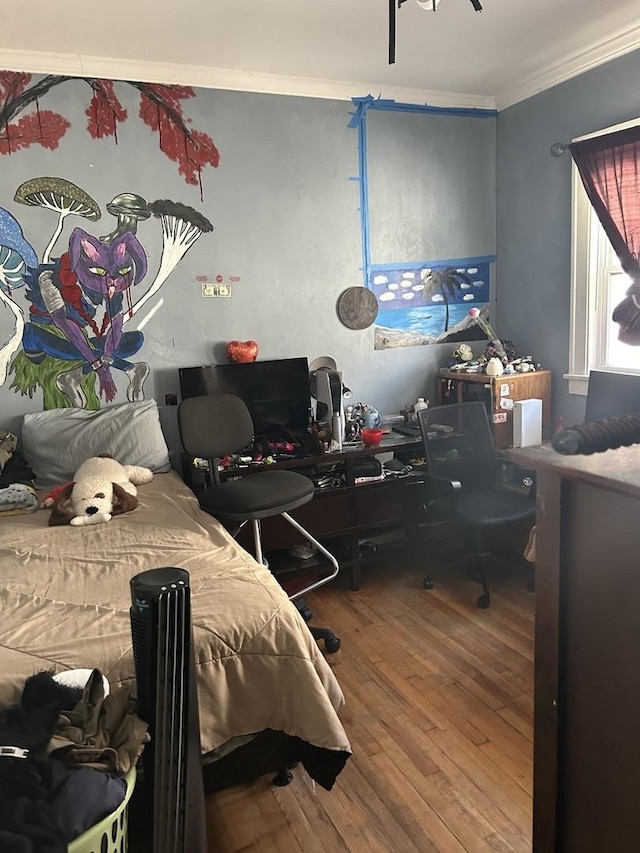 bedroom with wood-type flooring, crown molding, and a desk