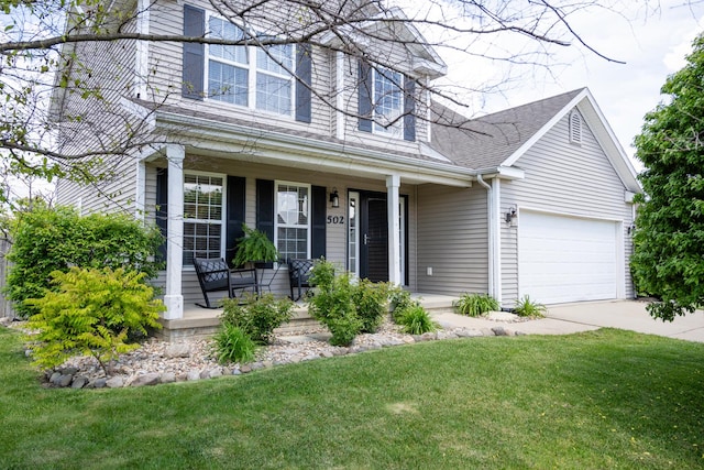 502 Deerpath St, Tolono, IL 61880 - view of front facade featuring a porch, driveway, a front lawn, and an attached garage