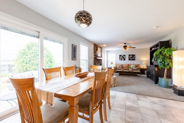 502 Deerpath St, Tolono, IL 61880 - dining area featuring light colored carpet, a ceiling fan, light tile patterned floors, and a large fireplace