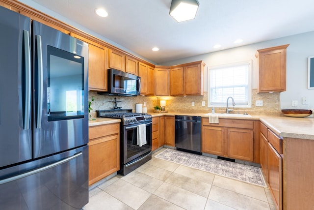 502 Deerpath St, Tolono, IL 61880 - kitchen with appliances with stainless steel finishes, a sink, light countertops, tasteful backsplash, and light tile patterned flooring