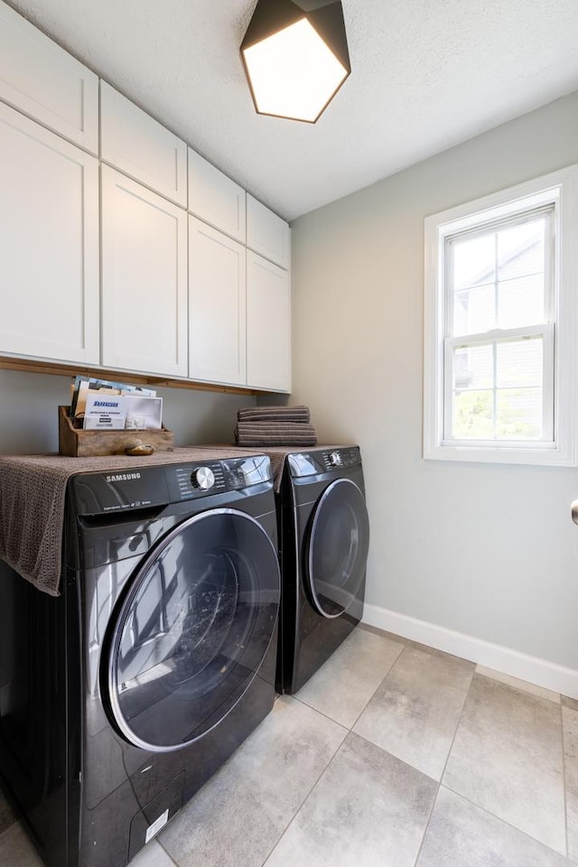 502 Deerpath St, Tolono, IL 61880 - laundry area with cabinet space, separate washer and dryer, baseboards, and light tile patterned floors