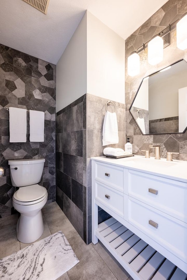 502 Deerpath St, Tolono, IL 61880 - bathroom featuring tile walls, toilet, and vanity
